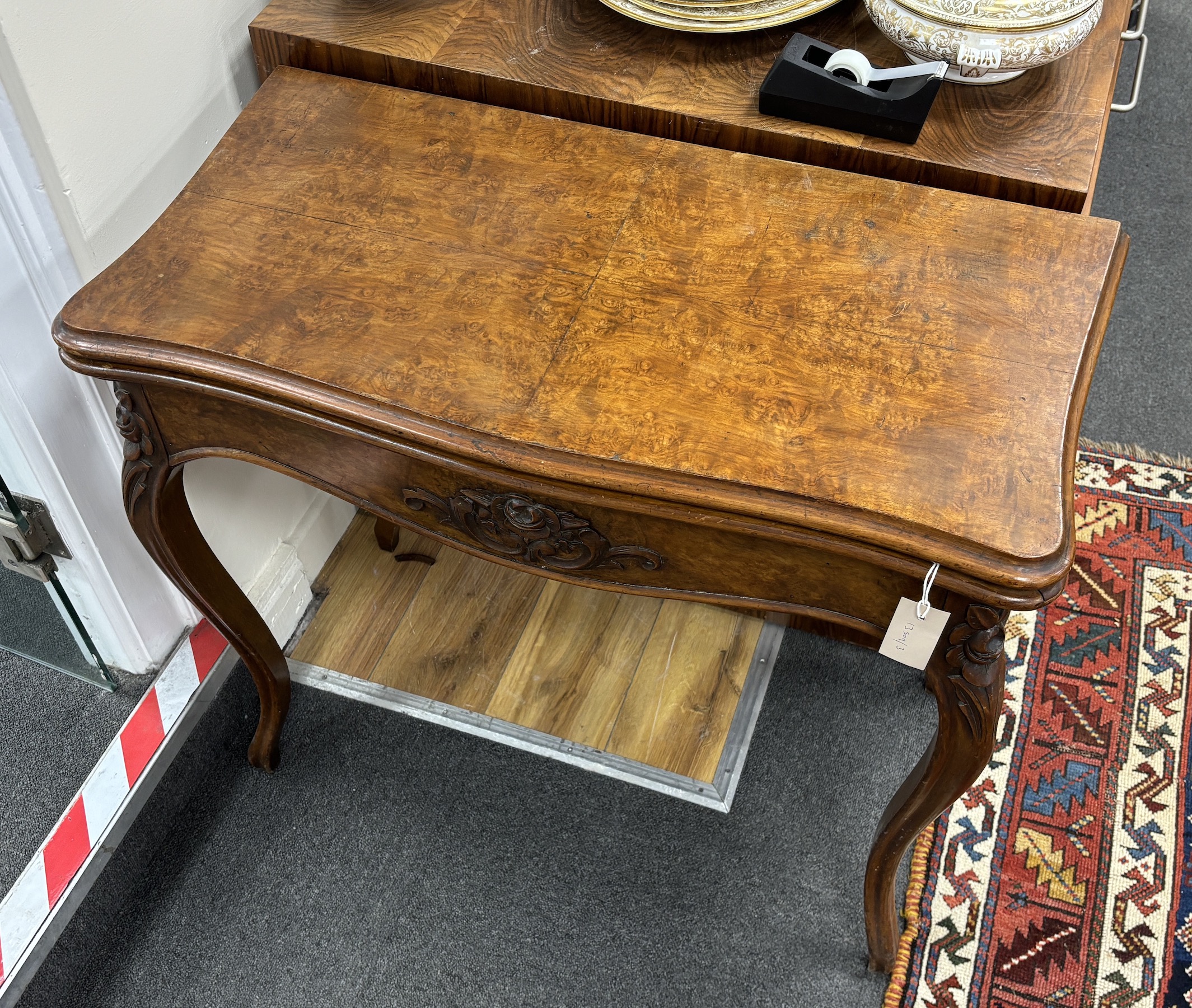 A Victorian walnut serpentine folding card table, width 80cm, depth 40cm, height 73cm.